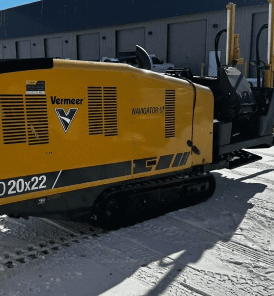 Yellow Vermeer directional drill machine on a snowy ground.