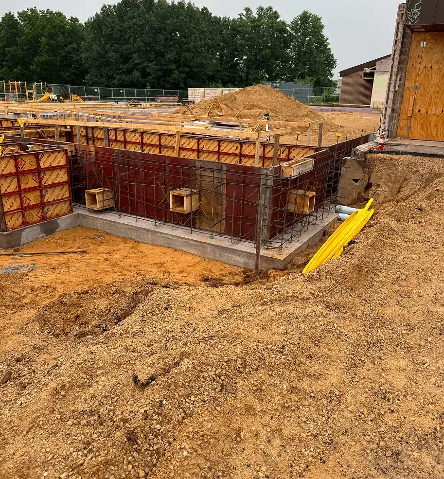 Construction site with foundation formwork and rebar for a building.